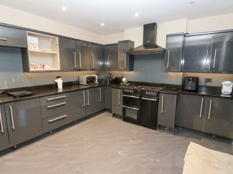 A kitchen with cabinets and appliances at Middleton Park House in Leeds