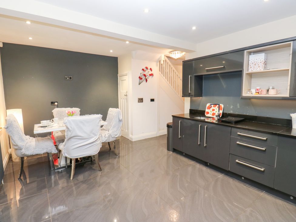 A kitchen with dining table and chairs at Middleton Park House in Leeds