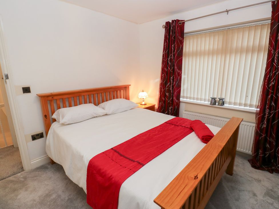 A bedroom with a bed and curtains at Middleton Park House Leeds