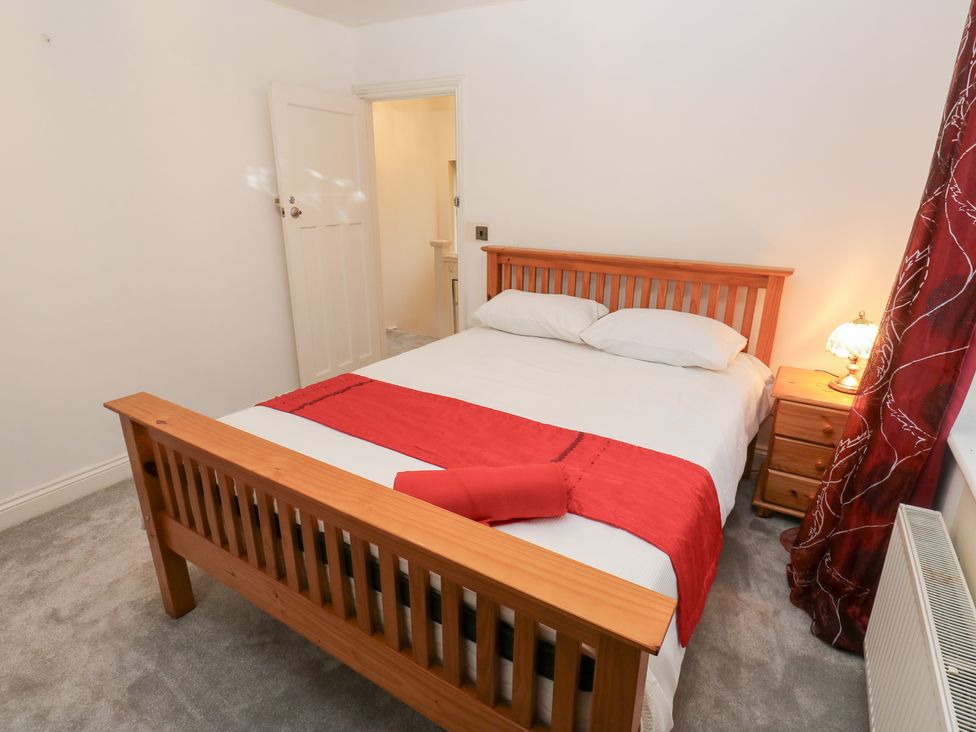 A bedroom with a bed and bedside table at Middleton Park House in Leeds
