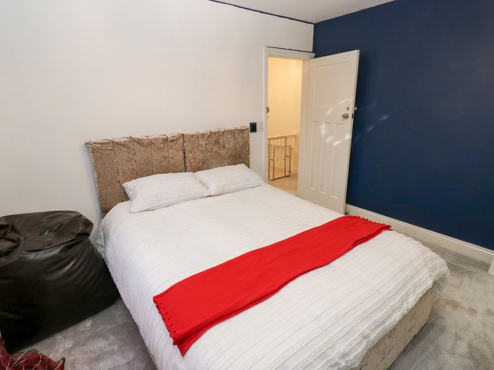 A bedroom with a bed and bean bag chair at Middleton Park House in Leeds