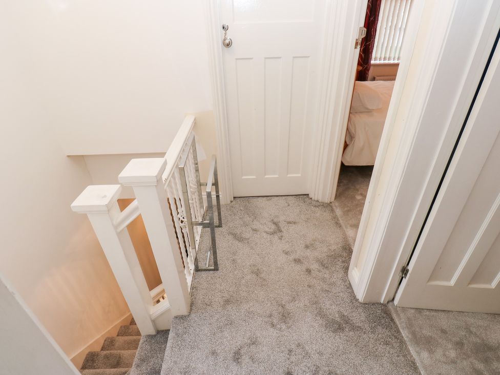 A staircase and hallway with a door at Middleton Park House in Leeds
