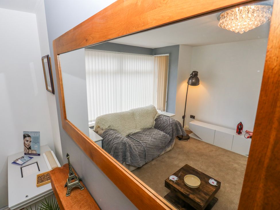 A living room with a sofa and lamp at Middleton Park House in Leeds