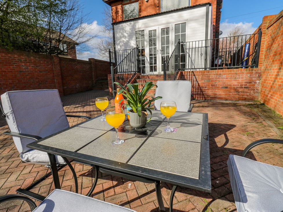 A patio with a table and chairs at Middleton Park House Leeds