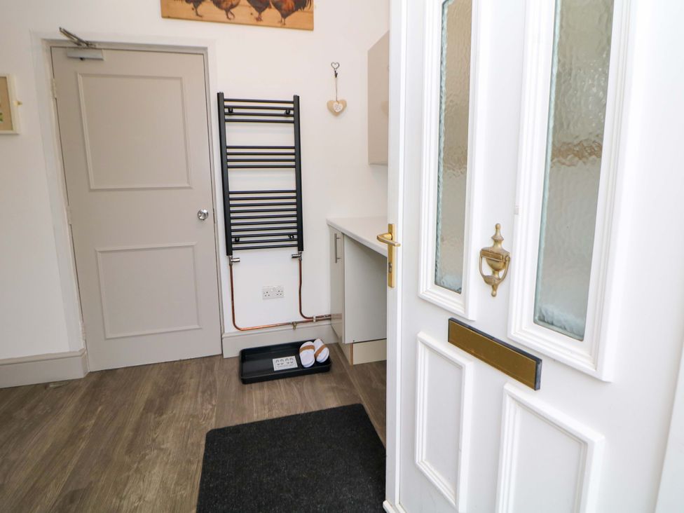 A hallway with a rack and a door at Nightingale House Stafford