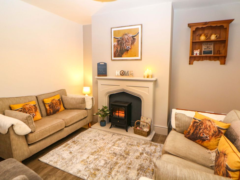A living room with sofas and a fireplace at Nightingale House in Stafford