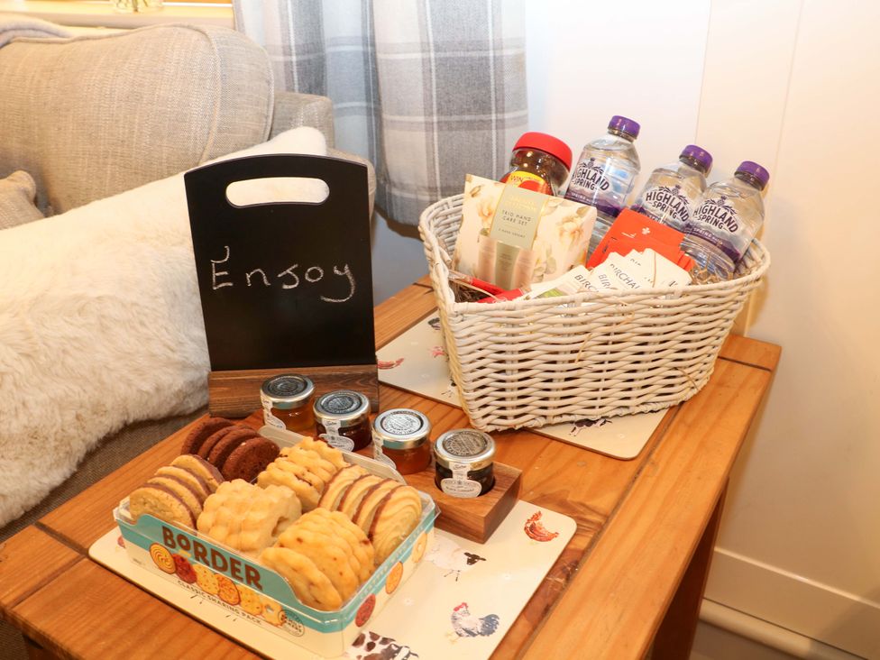A living room with cookies and drinks on a table at Nightingale House Stafford