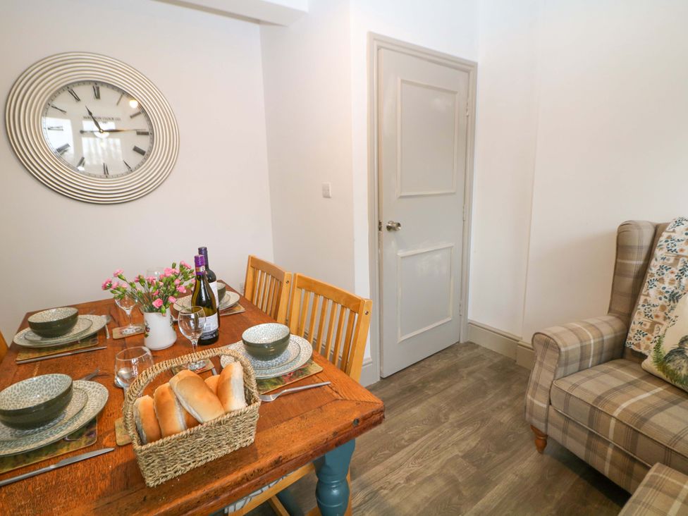 A dining room with a table set for a meal at Nightingale House Stafford