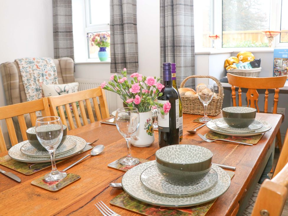 A dining room with a table set for meals at Nightingale House in Stafford