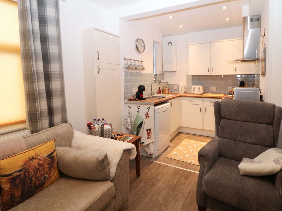 A kitchen with a sofa and armchair at Nightingale House Stafford