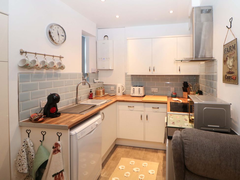 A kitchen with a sink and appliances at Nightingale House Stafford