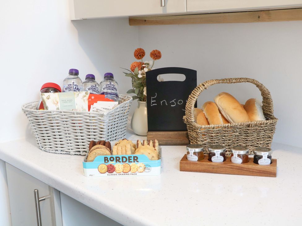 A kitchen countertop with food and drinks at Nightingale House in Stafford