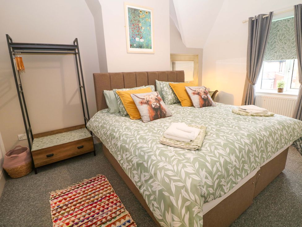 A bedroom with a bed and wardrobe at Nightingale House Stafford