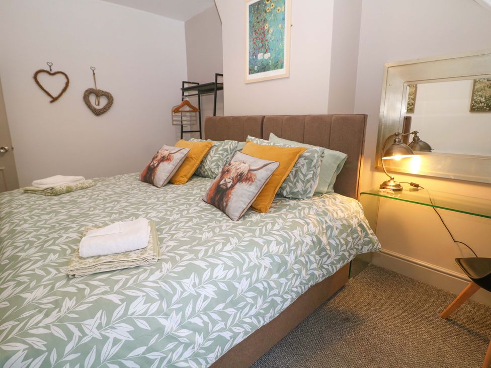 A bedroom with a bed and decorative items at Nightingale House Stafford