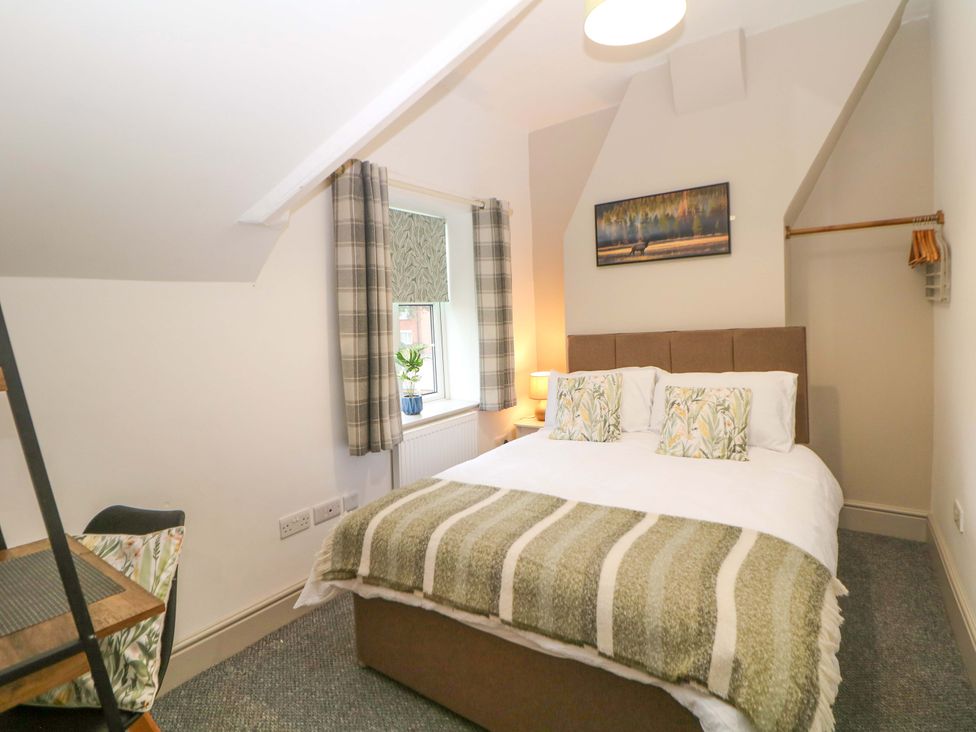 A bedroom with a bed and window at Nightingale House Stafford