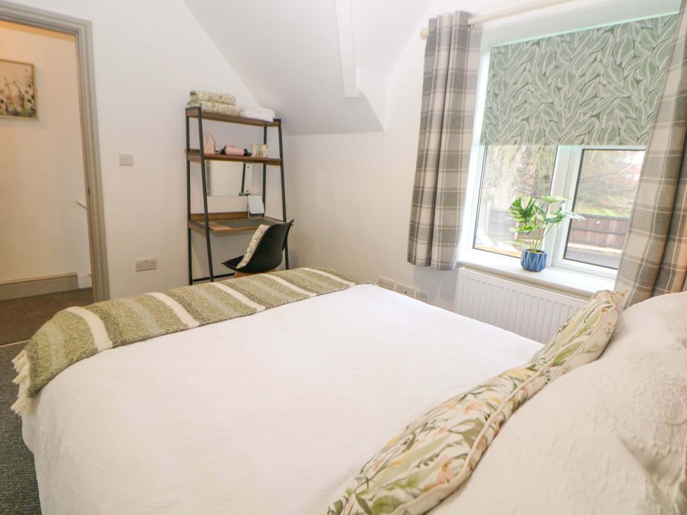 A bedroom with a bed and a desk at Nightingale House Stafford