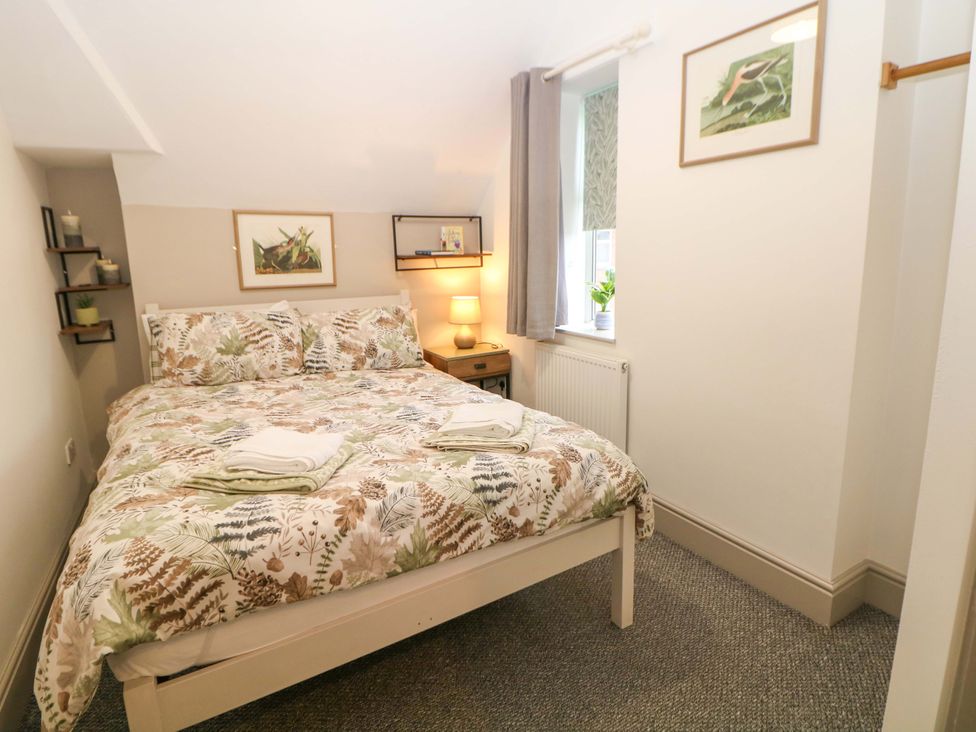 A bedroom with a bed and shelves at Nightingale House Stafford