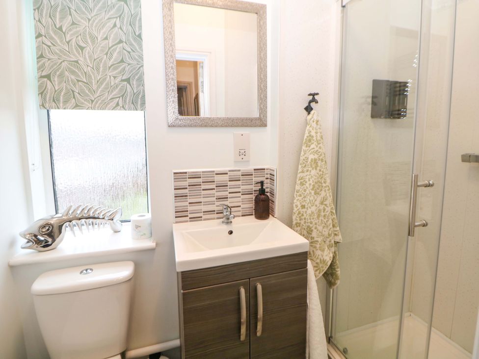 A bathroom with a shower and sink at Nightingale House Stafford