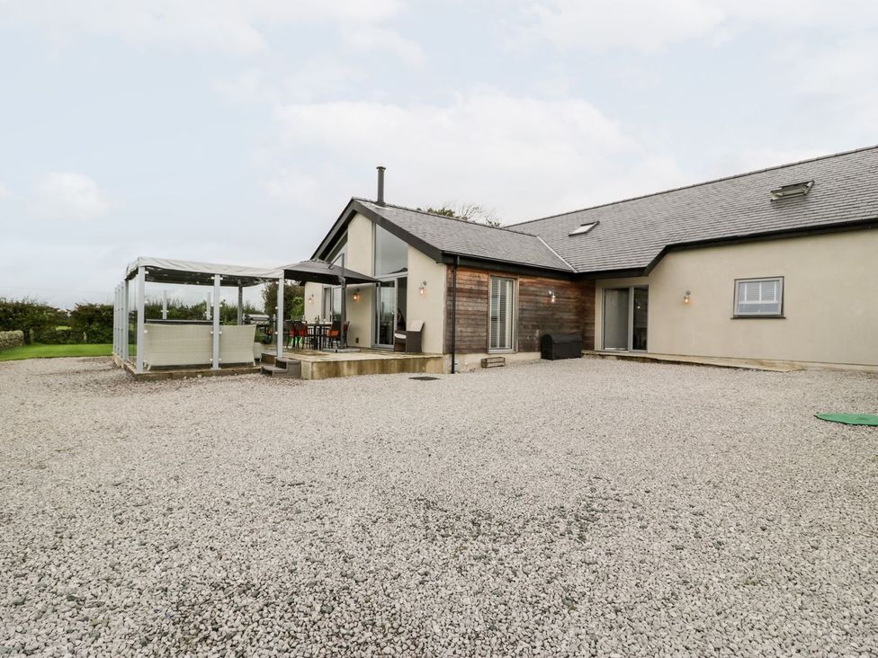A house with a patio and outdoor seating at Cae Sam in Pentraeth