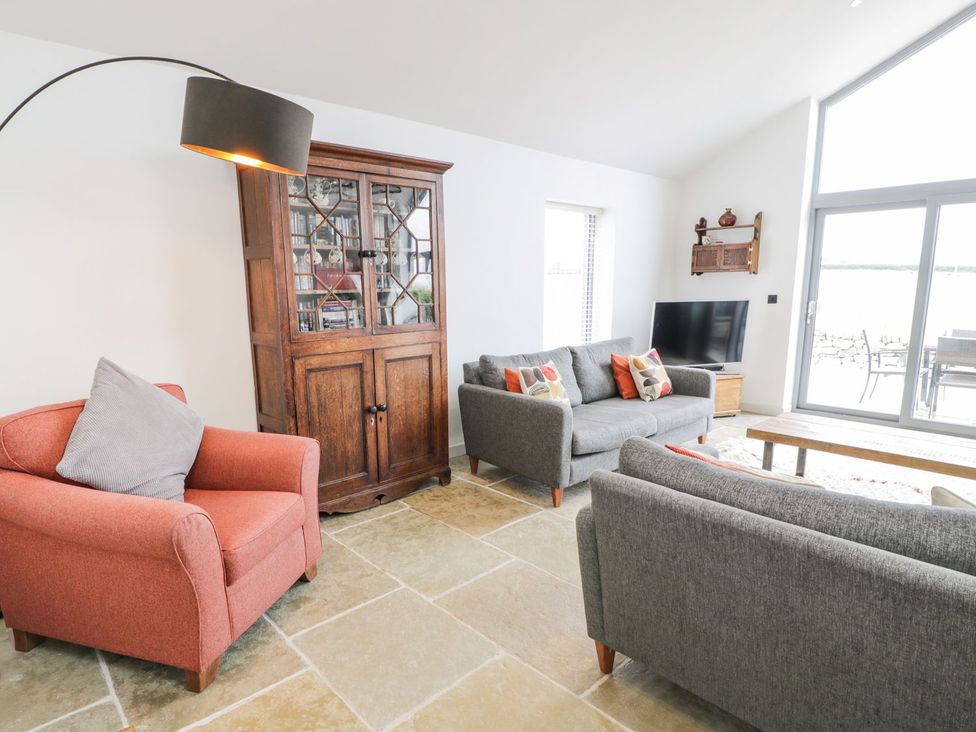 A living room with sofas and a coffee table at Cae Sam in Pentraeth