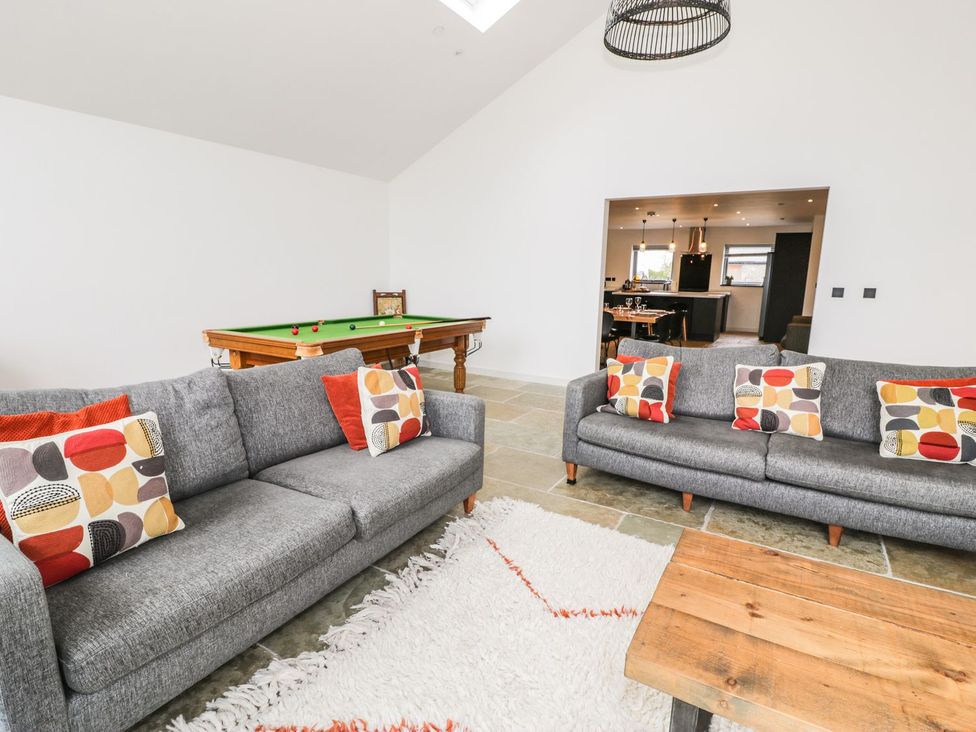 A snug with sofas and a pool table at Cae Sam in Pentraeth