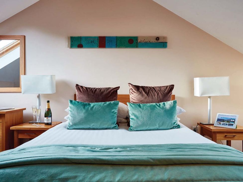 A bedroom with a bed and nightstands at Duplex Apartment in Penrith