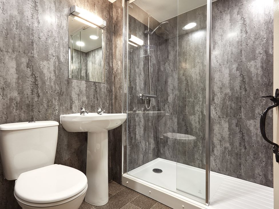 A bathroom with a toilet, sink, and shower at Derwent in Penrith
