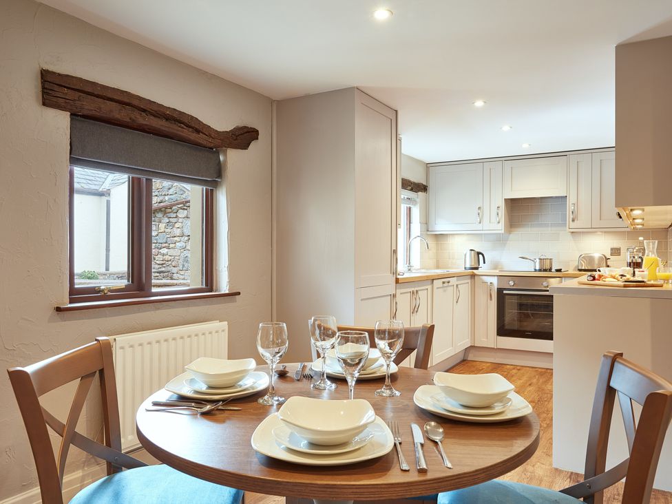 A kitchen with a dining table set at Derwent (Pet) Penrith