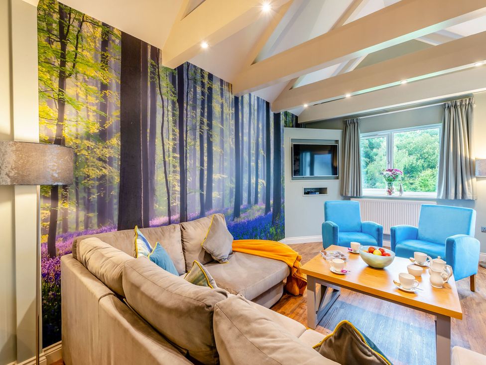 A living room with a sofa and chairs at The Whitbarrow Den in Penrith