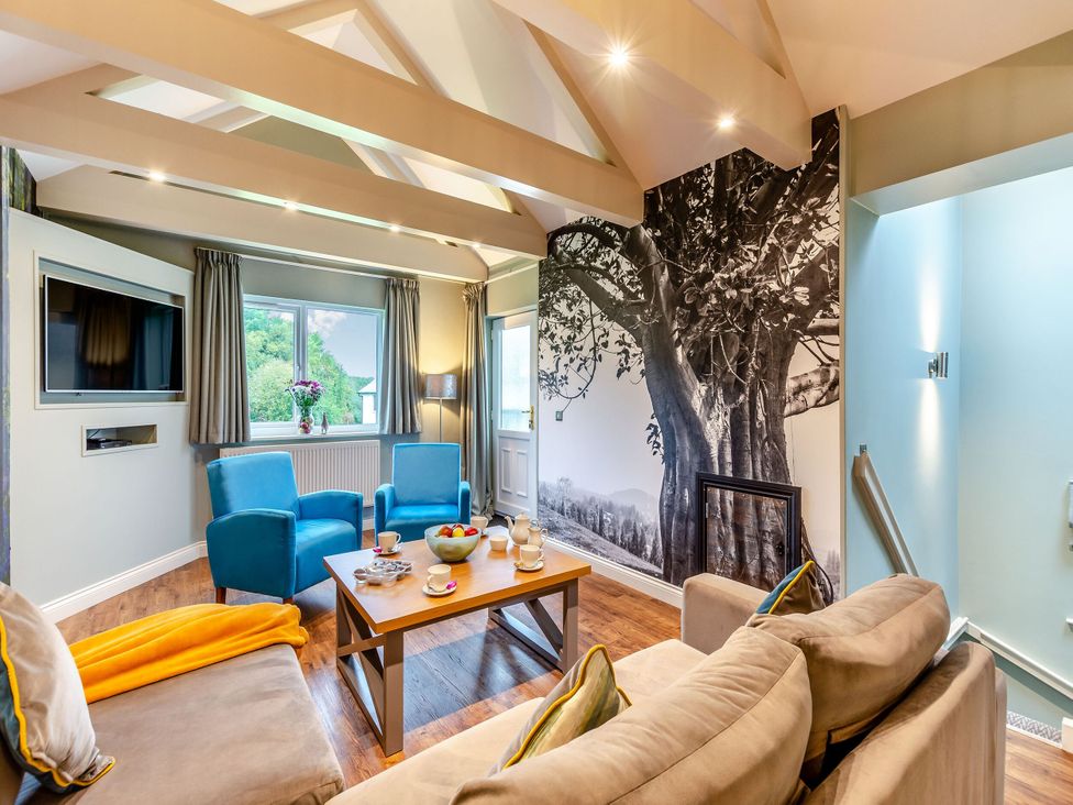 A living room with a tv and coffee table at The Whitbarrow Den Penrith