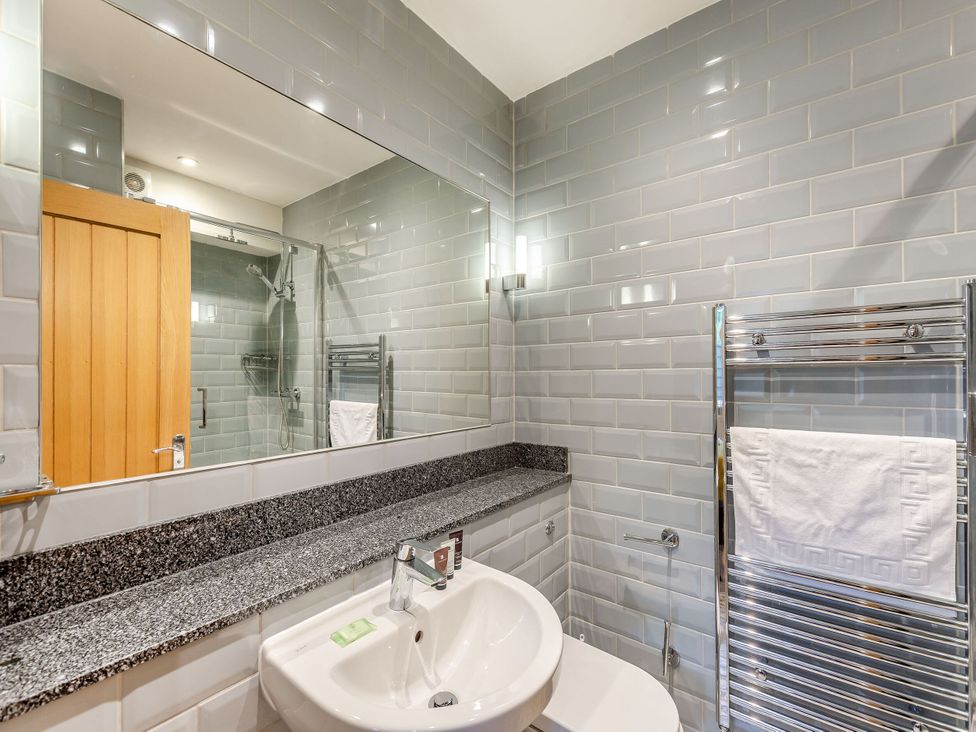 A bathroom with a sink and mirror at The Whitbarrow Den in Penrith