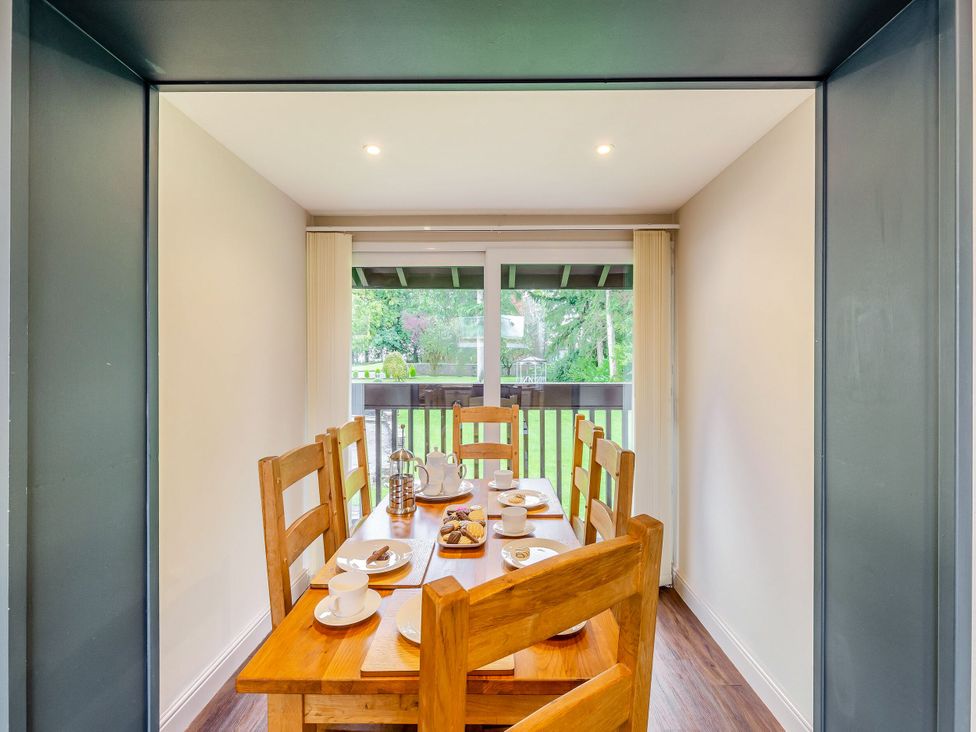 A dining room with a table set for tea at Caldew Cottage Spa in Penrith