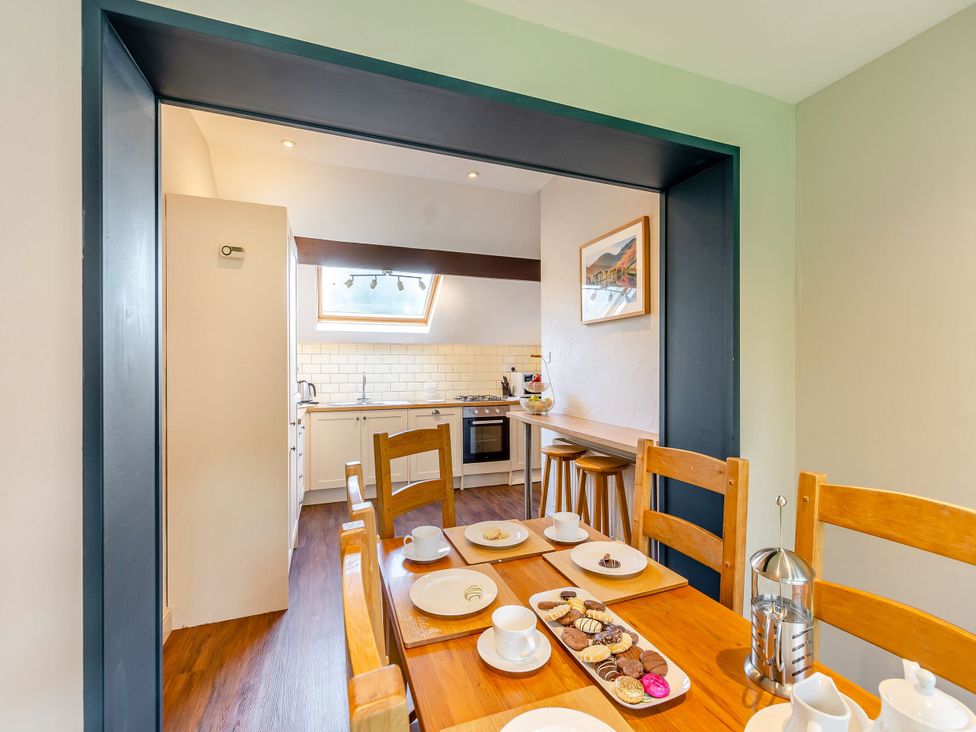 A dining room with a table set for tea and cookies at Caldew Cottage Spa Penrith