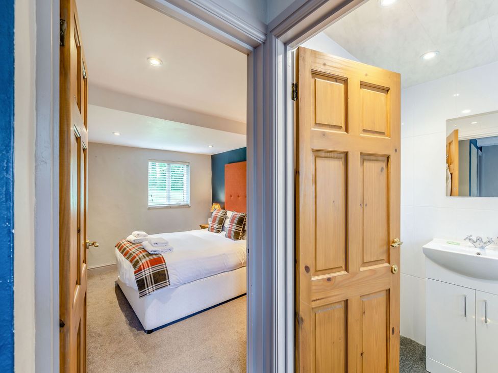 A bathroom and bedroom view in Caldew Cottage Spa Penrith