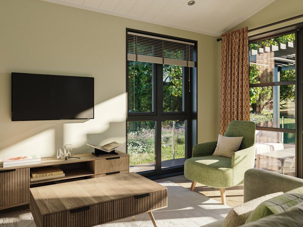 A living room with a television and an armchair at Hesk in Penrith