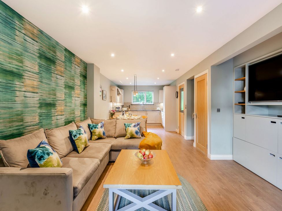 A living room with a sofa and coffee table at The Troutbeck Den Spa Penrith