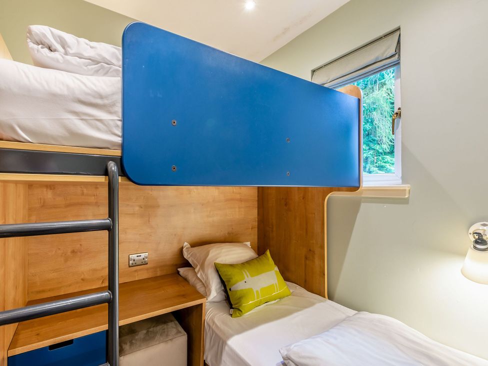 A bedroom with a bunk bed and a desk at The Troutbeck Den Spa Penrith