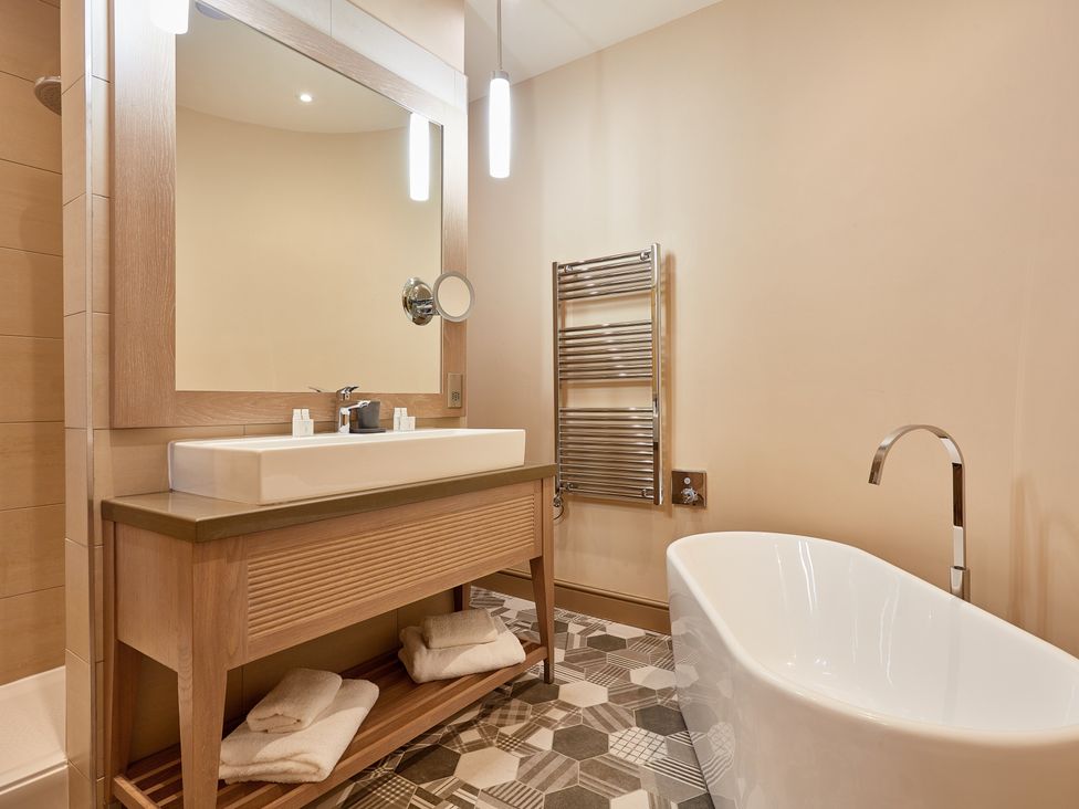 A bathroom with a sink and bathtub at The Farmhouse 1 in Penrith