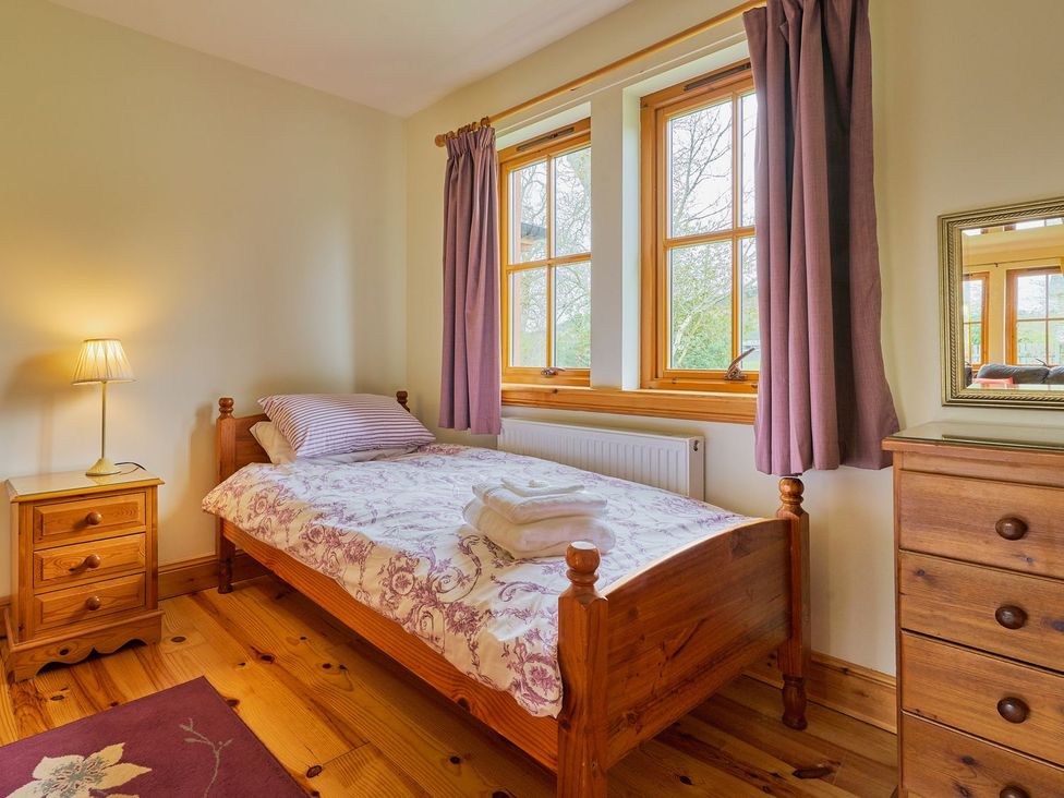 A bedroom with a single bed and window at Holly House in Blairgowrie