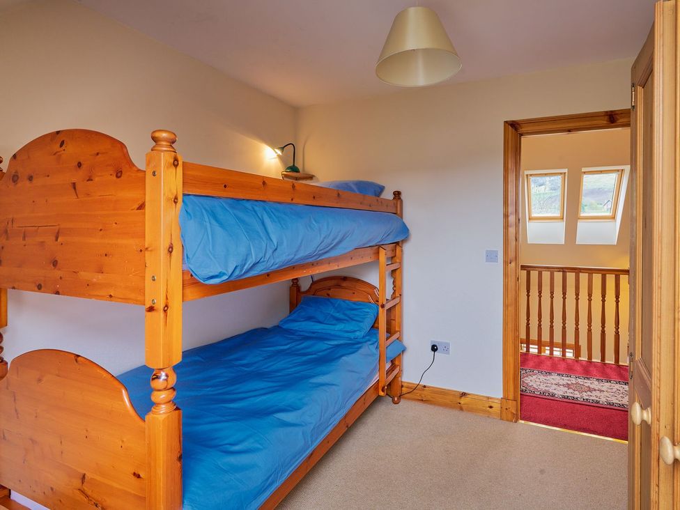 A bedroom with a bunk bed and a staircase at Holly House in Blairgowrie
