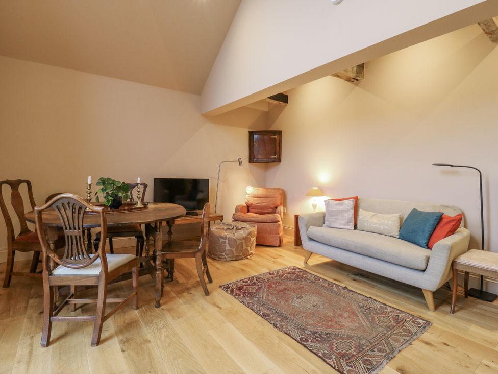 A living room with a dining table and seating area at The Apartment in Oving near Whitchurch, Buckinghamshire