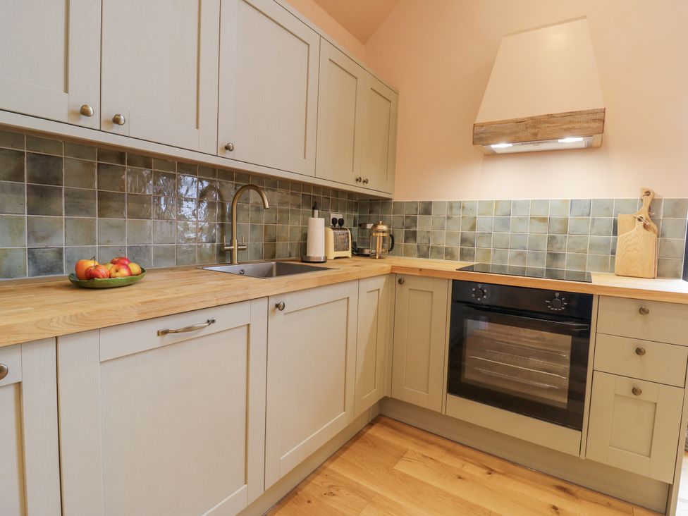 A kitchen with cabinets and a sink at The Apartment in Oving near Whitchurch, Buckinghamshire
