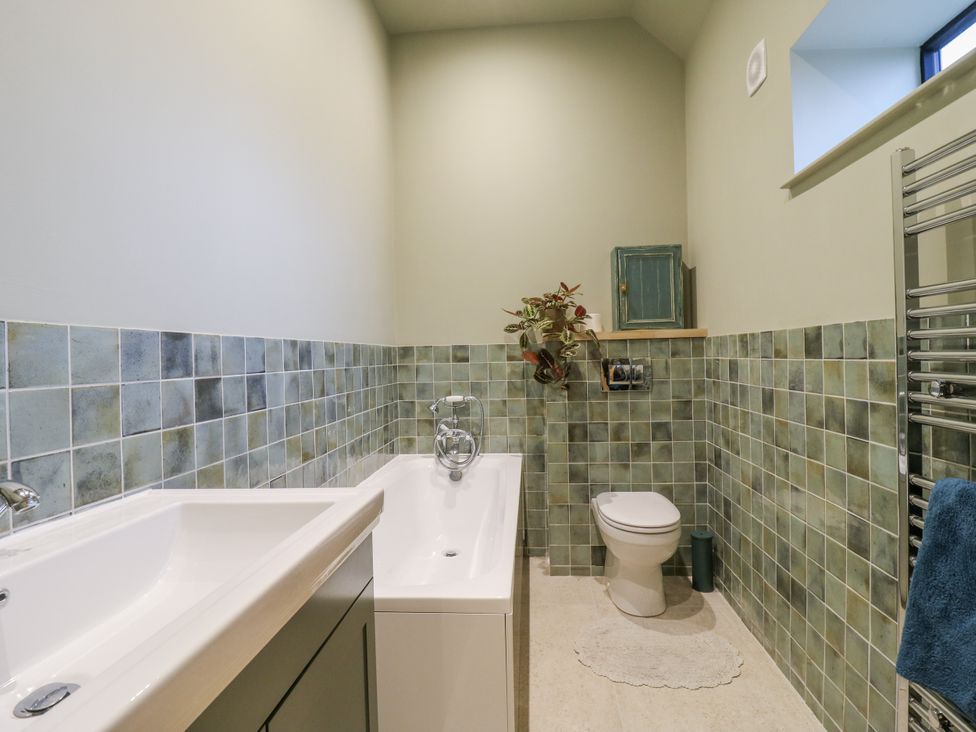 A bathroom with a bathtub and a toilet at The Apartment Oving near Whitchurch, Buckinghamshire