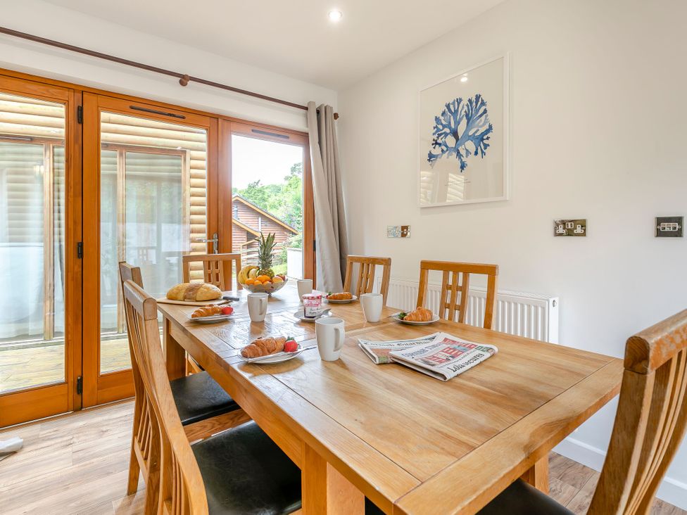 A dining room with a table and chairs at Treehouse Spa in Perranporth