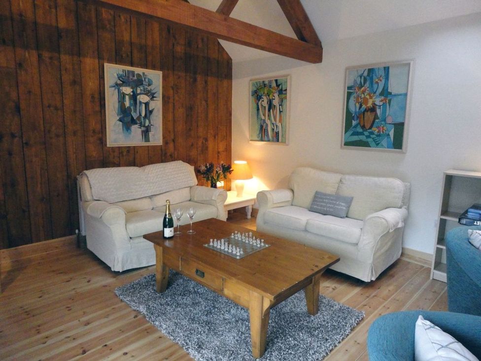 A living room with a sofa and coffee table at Nethercote Byre Minehead