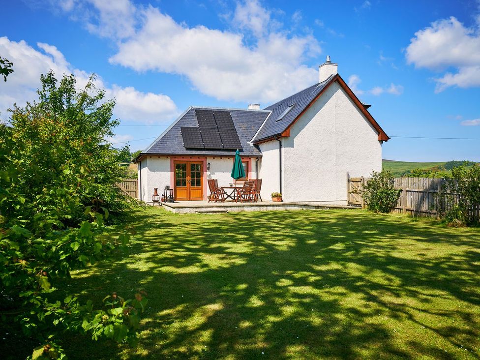A house with solar panels and patio furniture at Hazel Lodge in Blairgowrie