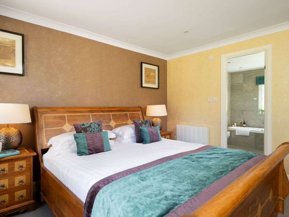 A bedroom with a bed and bedside tables at The Allensford (Pet) Slaley