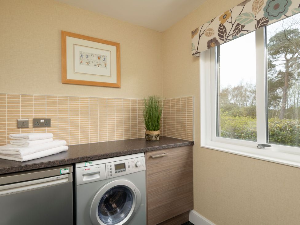 A utility room with washing machine and towels at The Allensford (Pet) in Slaley