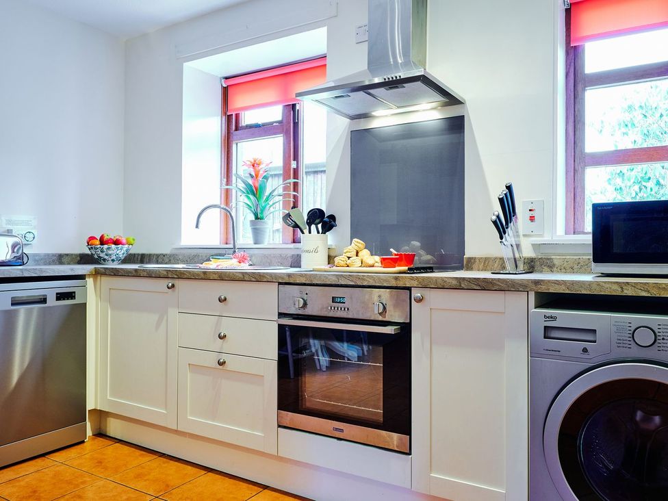 A kitchen with appliances and utensils at West Lodge in Kirriemuir