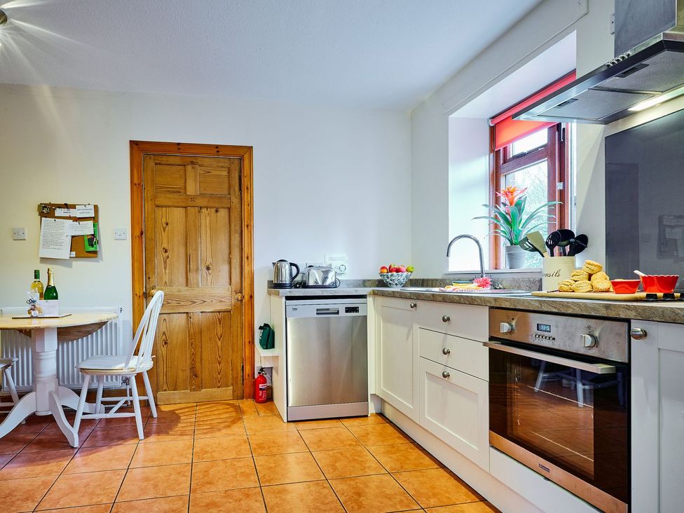 A kitchen with a table and chairs at West Lodge in Kirriemuir